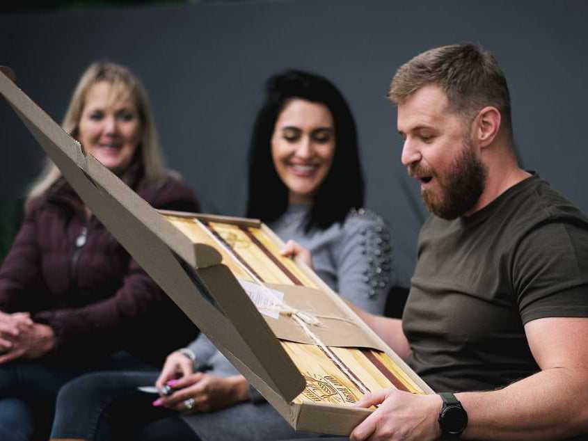 A BraaiPlank gift being opened